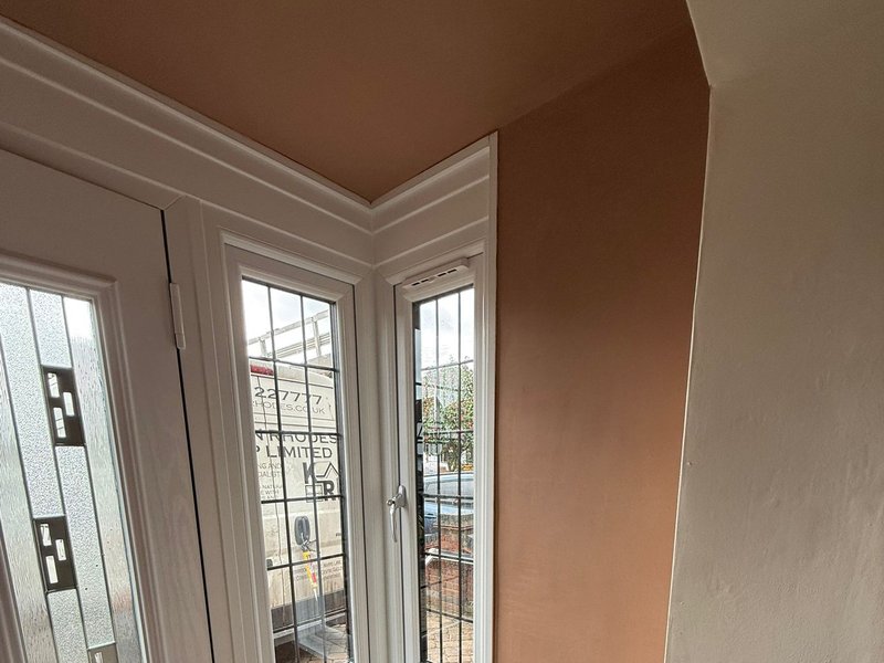 A freshly skimmed room with flat walls, a plastered corner and neat door reveals
