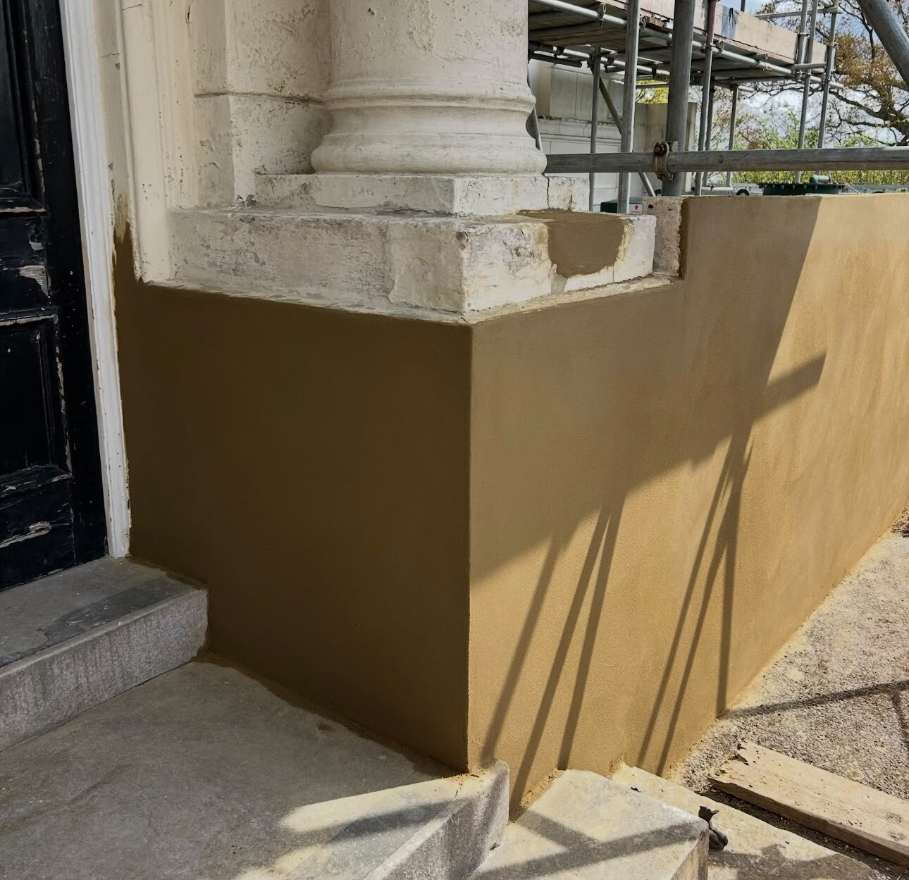 A render repair blended into an existing elevation